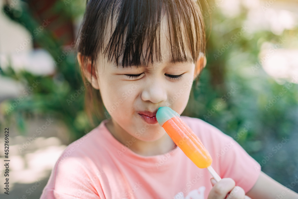 Cute happy baby girl are eating ice cream in summer. Picture for concept of sweet ,fat ,obesity and diabetes in children. Cute happy baby girl are eating ice cream in summer. Picture for concept of sweet ,fat ,obesity and diabetes in children.