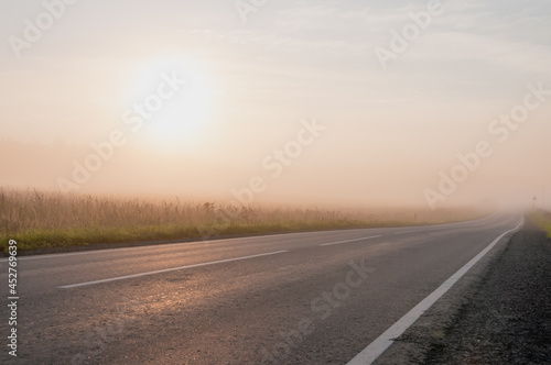 Landscape with a view of a foggy road, side view © grek881