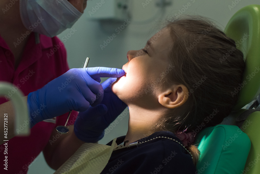 child is being examined by an orthodontist child is being examined by an orthodontist