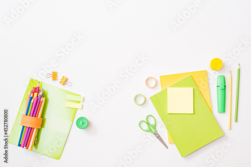Flat lay frame with school and office supplies on a white background