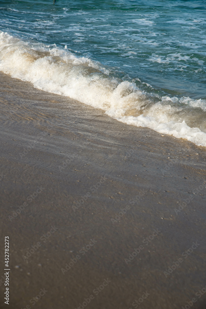 Sea or ocean tropical landscape view. Sea waves under the sun. Summer vacation and travel concept. Water wave surface. Sand beach. 