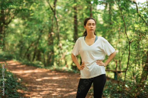 Portrait of woman relax after training at summer forest. The concept of cross-country running © _KUBE_