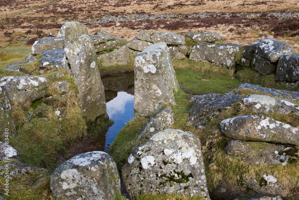 The remains of a characteristic round house, with prominent door posts, in Grimspound, one of the best known prehistoric settlements on Dartmoor, Devon, UK