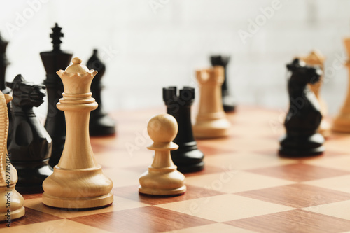 Tela Chessboard with game pieces on light background