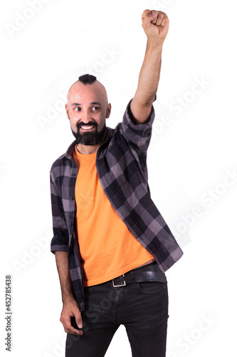 Successful hispanic young man rising his fist in sign of victory