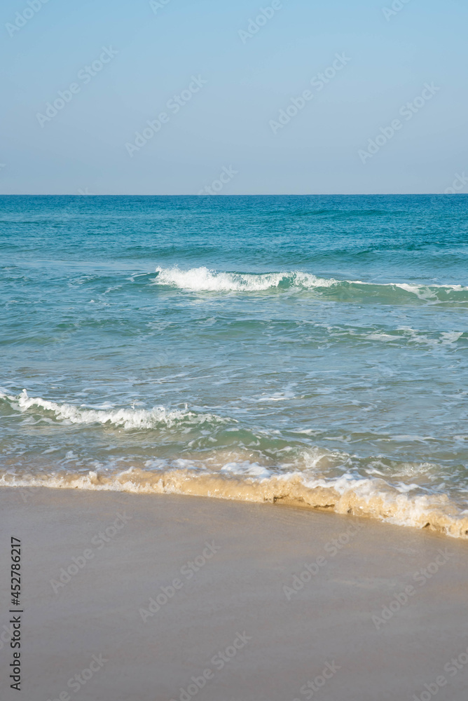 Sea or ocean tropical landscape view. Sea waves under the sun. Summer vacation and travel concept. Water wave surface. Sand beach. 