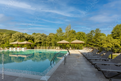 Fototapeta Naklejka Na Ścianę i Meble -  Outdoor swimming pool in a modern hotel