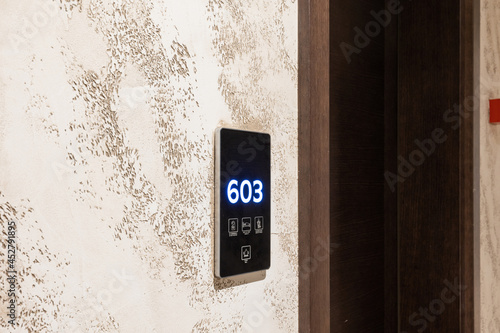 Hotel room number mounted on a wall