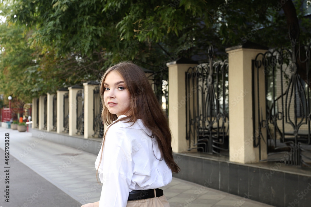 Portrait of Gorgeous young Woman with long is smiling Charmingly at the Camera. An attractive young Woman is walking down the Streets, turns to Camera, showing sincerely Emotions slow motion Portrait of Gorgeous young Woman with long is smiling Charmingly at the Camera. An attractive young Woman is walking down the Streets, turns to Camera, showing sincerely Emotions slow motion