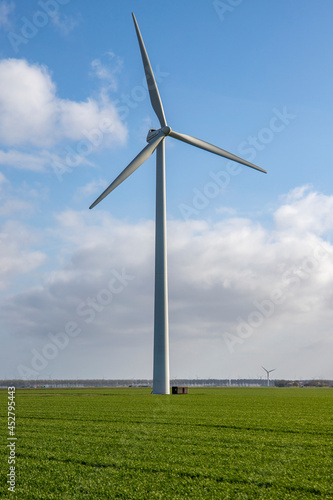 Windmill in grass field