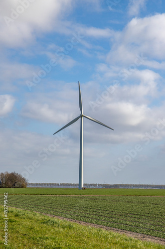 Windmill in grass field