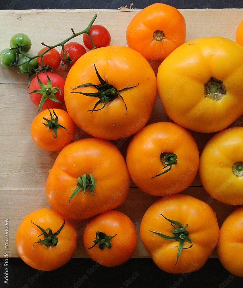 colorful tomatoes, yellow and red tomatoes, summer vegetables, tomatoes arranged in colors, tomatoes on a large plate, a sprig with tomatoes colorful tomatoes, yellow and red tomatoes, summer vegetables, tomatoes arranged in colors, tomatoes on a large plate, a sprig with tomatoes