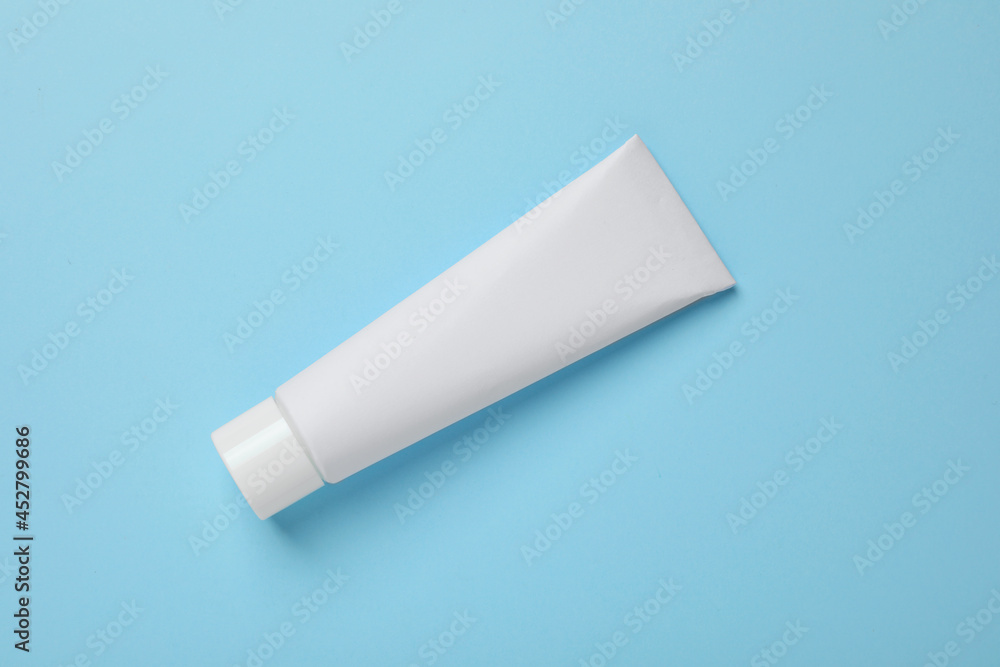Blank tube of toothpaste on light blue background, top view Blank tube of toothpaste on light blue background, top view