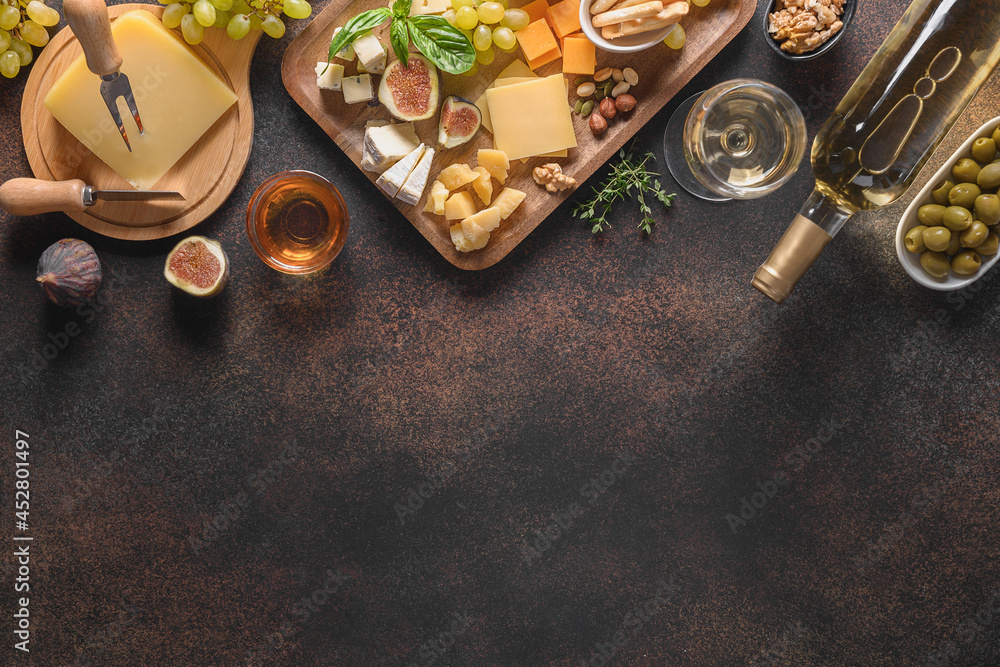 Cheese platter with grapes, nuts, figs on a brown background. Top view. Copy space. Appetizer for festive party. Cheese platter with grapes, nuts, figs on a brown background. Top view. Copy space. Appetizer for festive party.