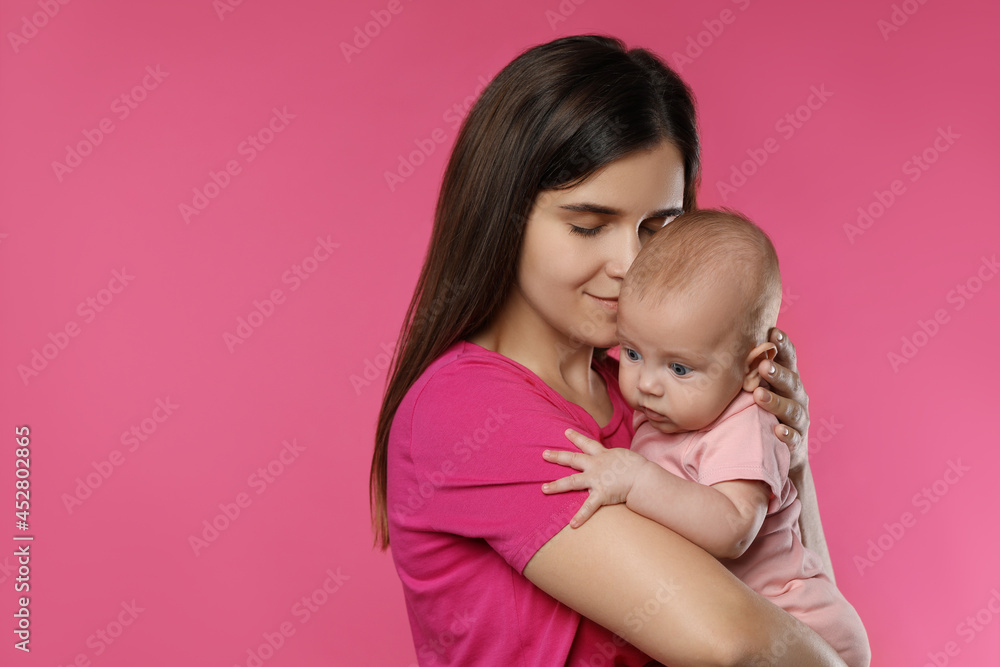 Beautiful mother with her cute baby on pink background. Space for text Beautiful mother with her cute baby on pink background. Space for text