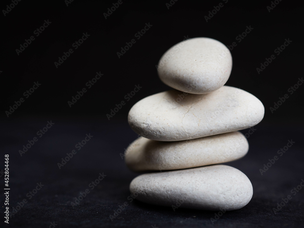 Stacked white stone on a black background Stacked white stone on a black background