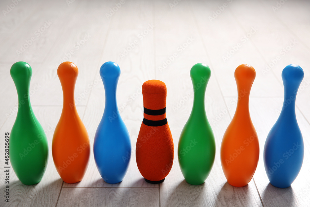 Fabric bowling pin among others on wooden floor. Diversity concept Fabric bowling pin among others on wooden floor. Diversity concept