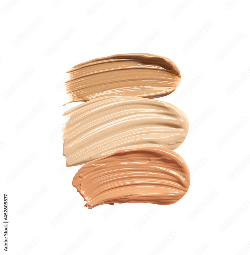 Different shades of liquid skin foundation on white background, top view Different shades of liquid skin foundation on white background, top view
