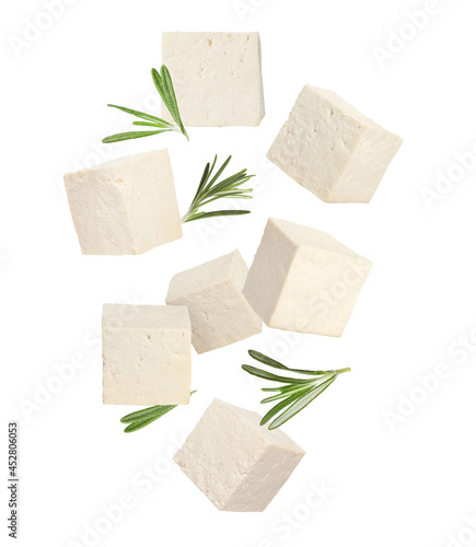Photos Cubes of raw tofu falling on white background