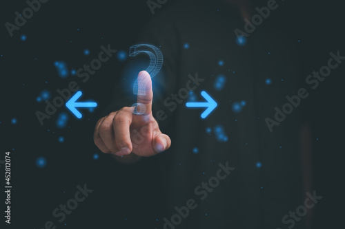 Man hand with Question mark and left and right arrows, Difficult decision and doubt concept. Right or left Decide Which Way To Go