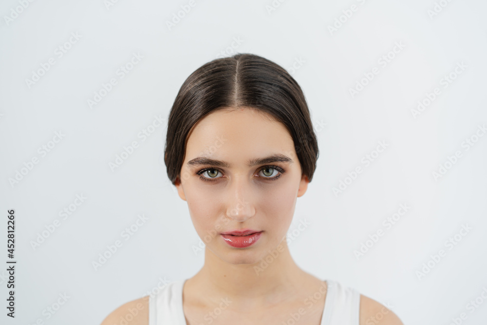 Girl with collected hair and minimal makeup portrait photo. Face photo. Minimalist makeup. Girl with collected hair and minimal makeup portrait photo. Face photo. Minimalist makeup.