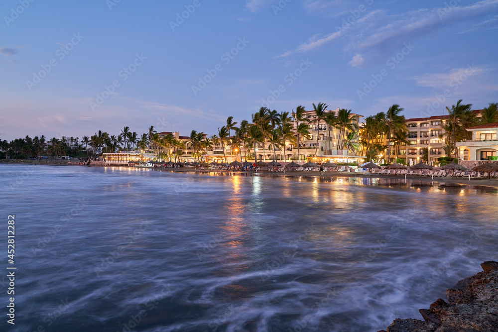 Scenic View of Mazatlán Mexico Hotel Beach front at Sunset with Blue Horizon  