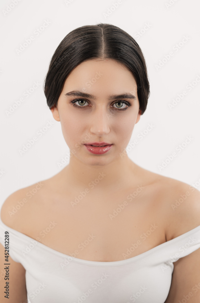 Portrait photo of a girl with a natural appearance. The hair is gathered in a bundle. Look straight. Portrait photo of a girl with a natural appearance. The hair is gathered in a bundle. Look straight.