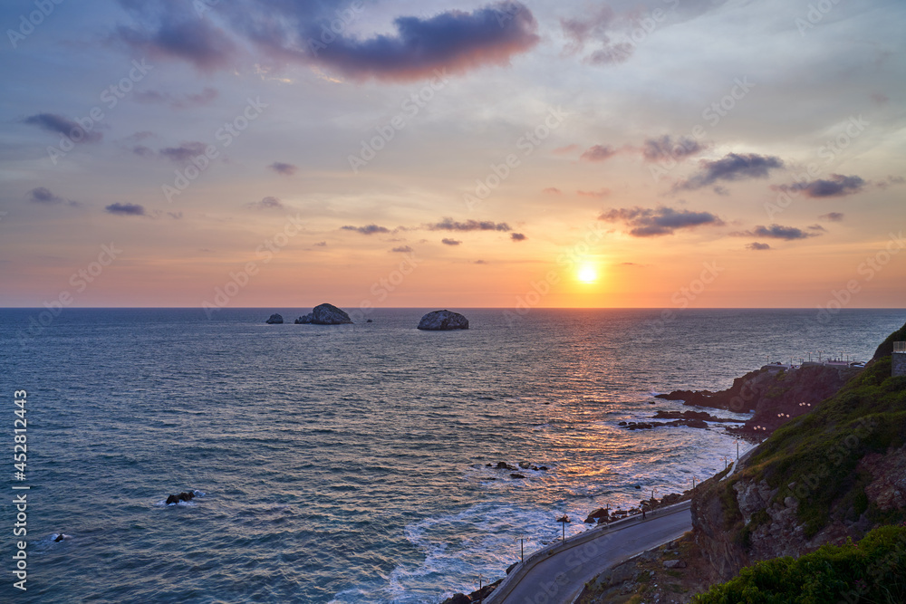 Mazatlán Mexico Beach Sunset with Costal Road and View of Rock Formations and Cliff. 