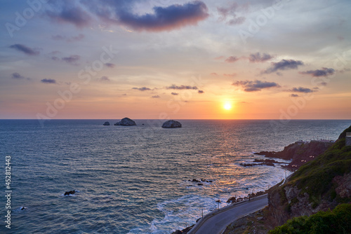 Mazatlán Mexico Beach Sunset with Costal Road and View of Rock Formations and Cliff. 