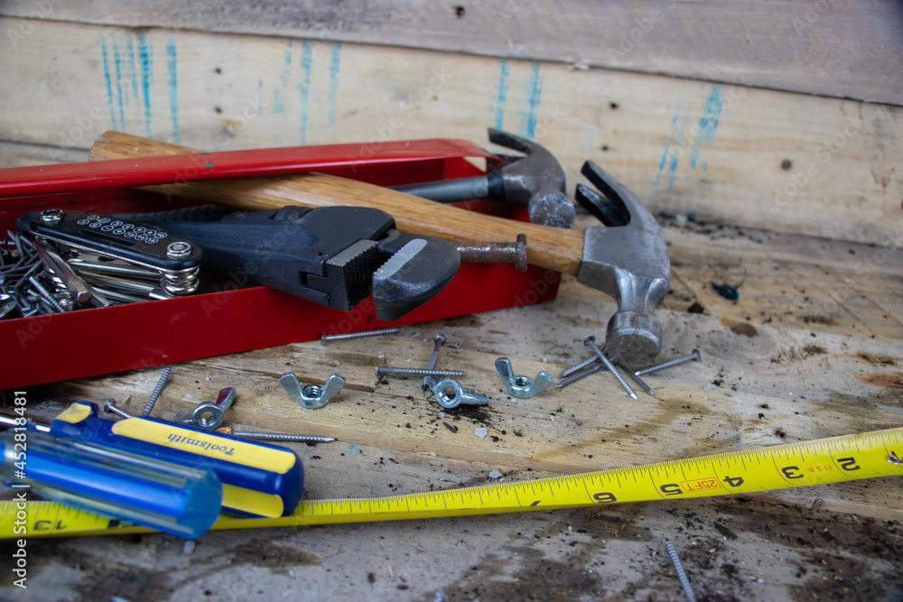 Red metal toolbox with hammer and screwdrivers