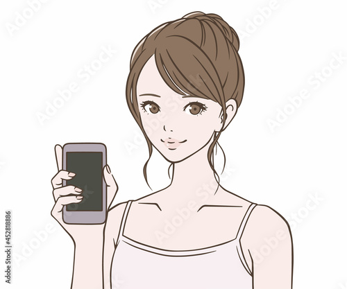 スマートフォンを持つキャミソールを着た女性