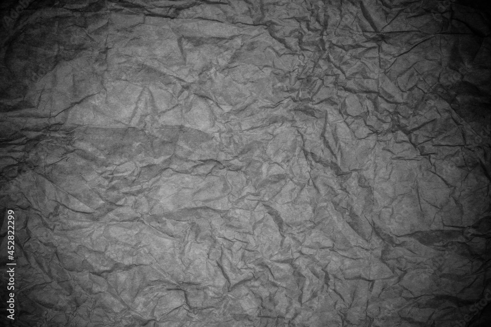 Black crumpled paper texture.