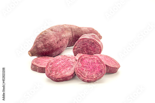 Purple yams or purple sweet potatoes isolated on white background. Side view. Vegan fruit and healthy fruits concept