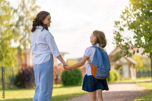 Parent and pupil going to school