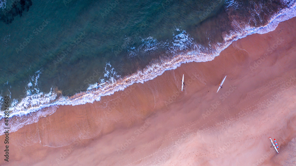 Top down aerial view over beach with boards, Gold Coast.