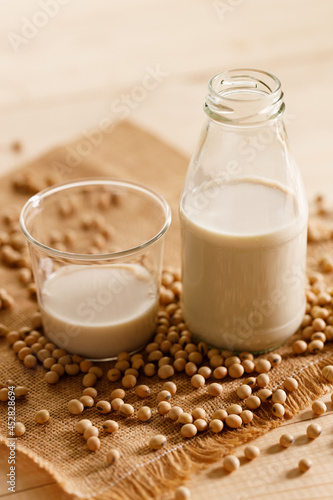 soy milk in a bottle on wooden table