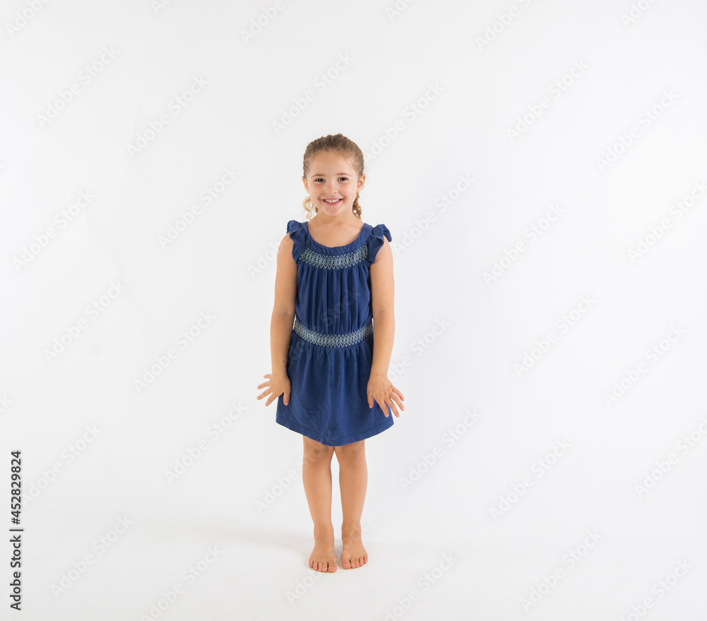 Excited happy preschool girl in blue dress isolated on white background