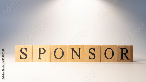 Sponsor word crafted from wooden cubesfinance and business.