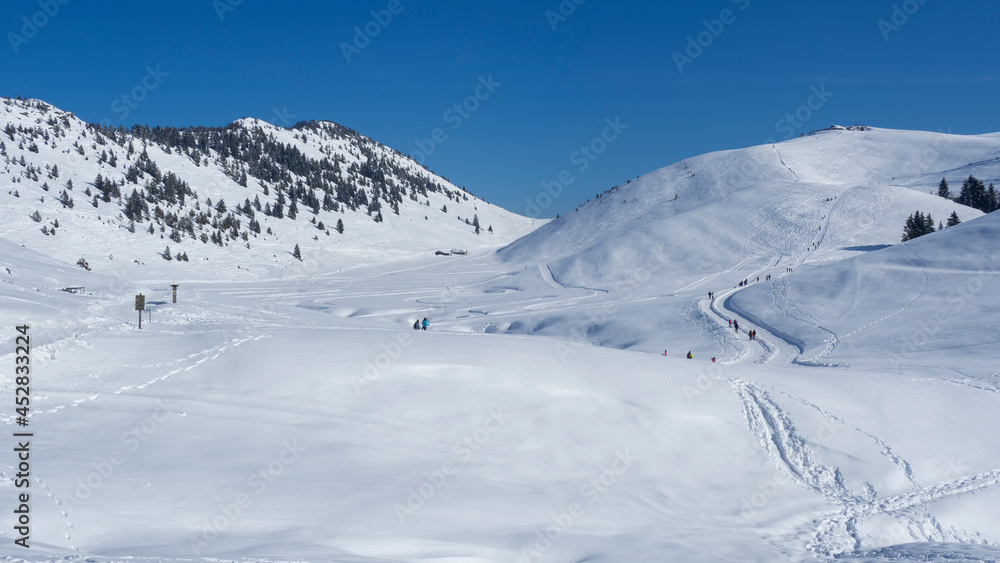 People walking or snowshoeing on mountain path with fresh snow. Feeling of freedom. Best day for mountain hikes. Snowy mountain landscape. Alpine contest. Winter time