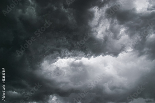 Swirling angry menacing dark grey stormy clouds