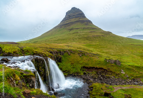 Waterfalls panorama and the mountain covered by grass near Olafsvik, Iceland