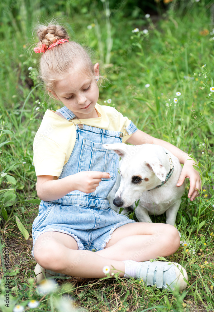 Little girl playing with a dog Little girl playing with a dog