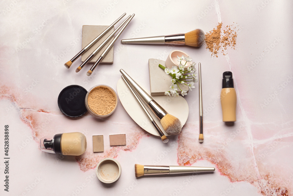 Set of makeup brushes with decorative cosmetics on light background Set of makeup brushes with decorative cosmetics on light background