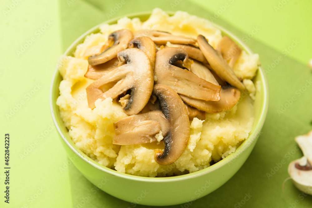 Bowl with tasty mashed potatoes and mushrooms on color background, closeup Bowl with tasty mashed potatoes and mushrooms on color background, closeup