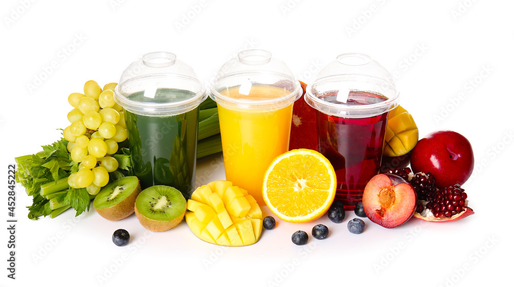 Plastic cups with healthy juice, fruits and vegetables on white background Plastic cups with healthy juice, fruits and vegetables on white background