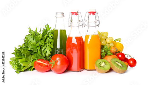 Fototapeta Naklejka Na Ścianę i Meble -  Bottles with healthy juice, fruits and vegetables on white background