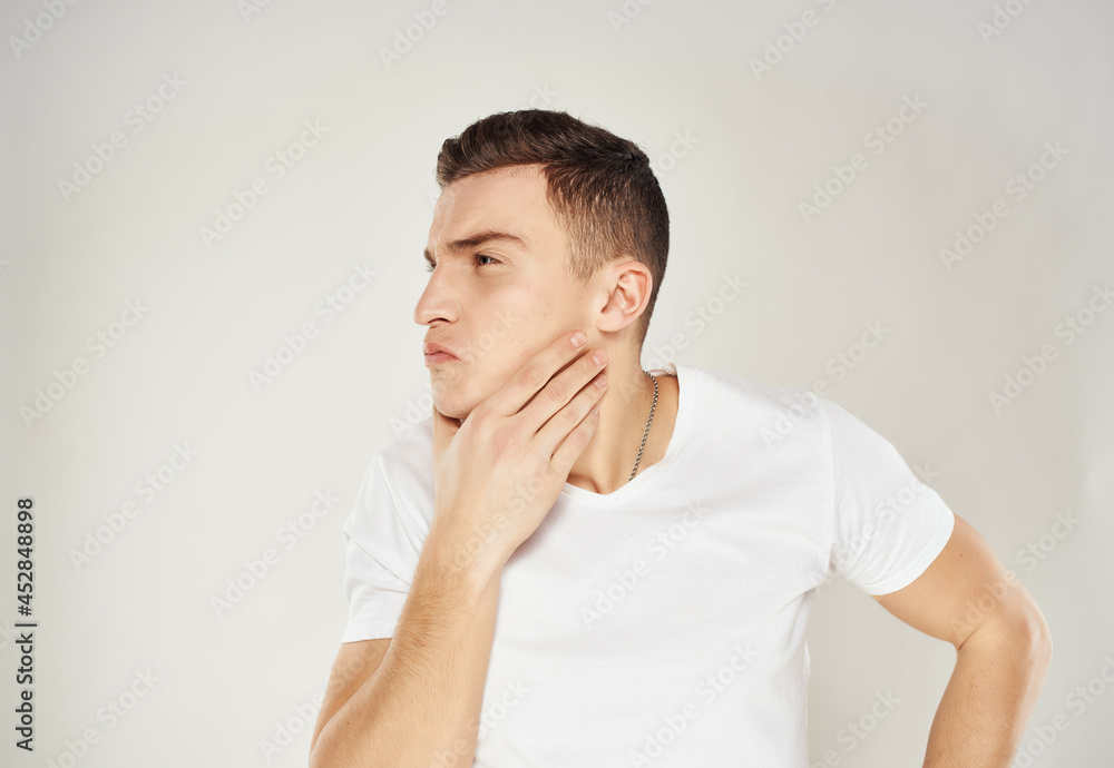 man with pensive facial expression in white t-shirt emotions isolated background