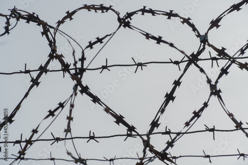An iron heart formed by barbed wire against a gray cold sky as a symbol of freedom and support for political prisoners