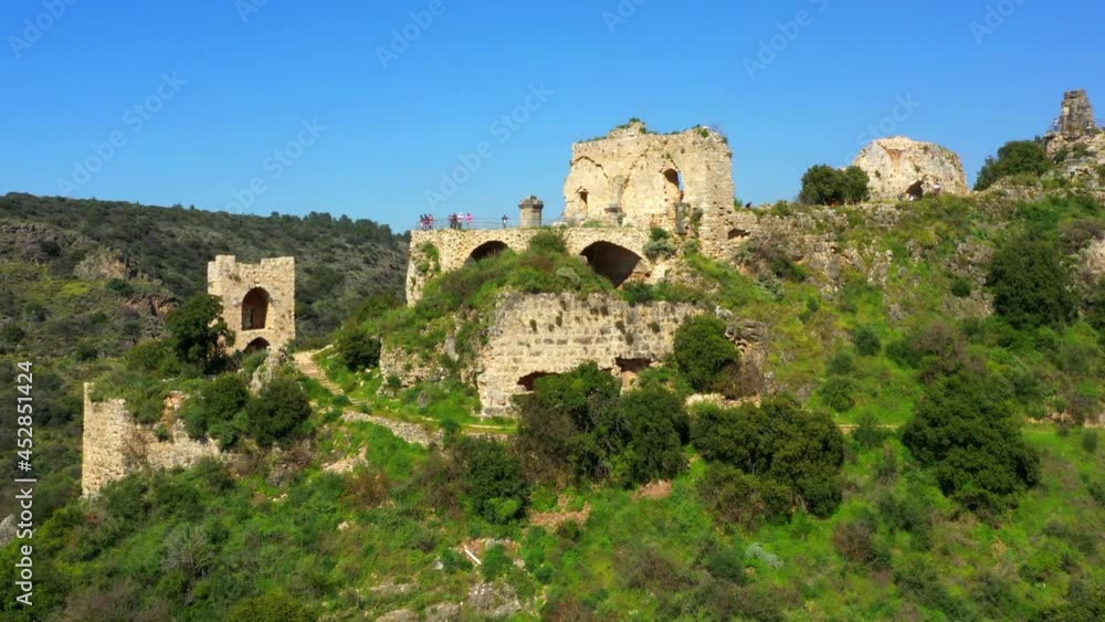 Aerial Forward Ascending Beautiful Old Fort On Mountain, Drone Flying Over People At Vacation During Sunny Day - Montfort Fortress, Israel Aerial Forward Ascending Beautiful Old Fort On Mountain, Drone Flying Over People At Vacation During Sunny Day - Montfort Fortress, Israel