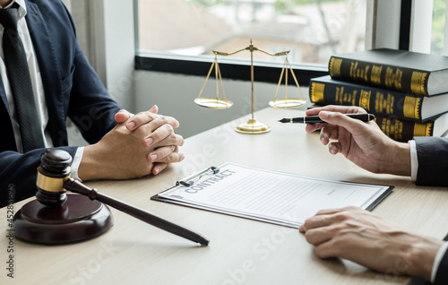 Male lawyers or a judge counseling clients about judicial justice and prosecution with scales, judges gavel, legal documents legal services concept